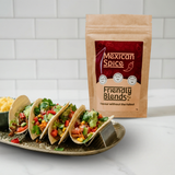 Tacos with various fillings on a plate next to a 'Friendly Blends Mexican Spice' package.